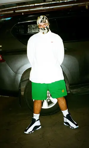 Feid wearing Supreme hat