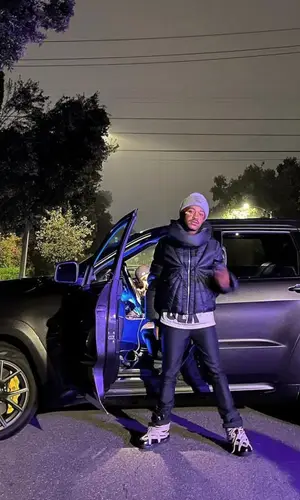 Lil Tracy’s Outfit in Rick Owens Jacket, Acne Studios Hat & Moncler (2021)