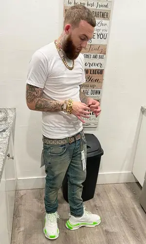 Gutta100 wearing Purple Brand jeans