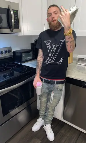 Gutta100 wearing Purple Brand jeans
