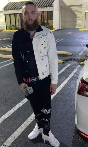 Gutta100 wearing Embellish NYC jeans