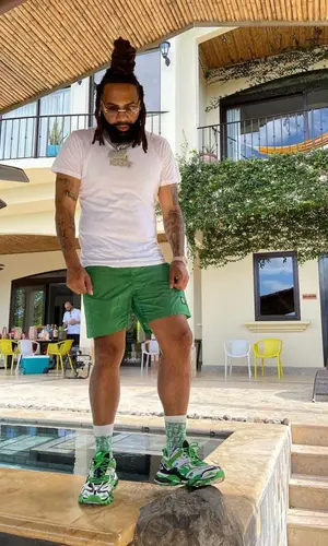 Money Man wearing Stone Island shorts