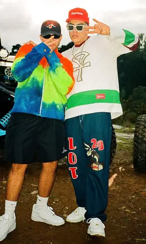Feid wearing The Elder Statesman jacket