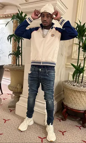 Lil Tjay wearing Gucci jacket