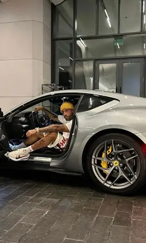 Nicky Jam wearing Dior bag