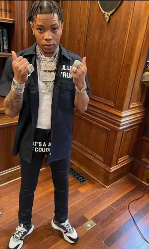Lil Migo wearing Awful Lot of Cough Syrup shirt