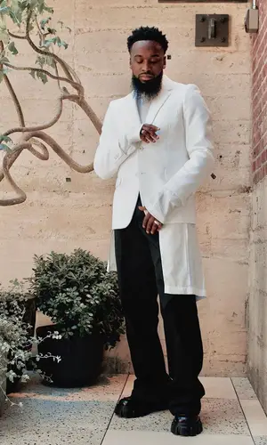 Dante Bowe wearing Prada boots