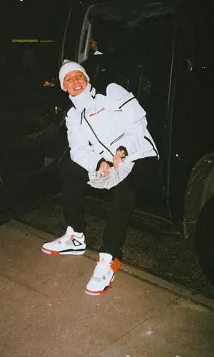 Aitch wearing Prada jacket
