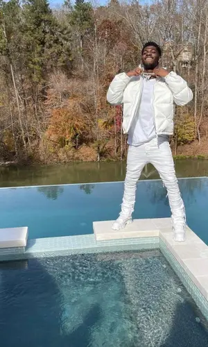 Lil Nas X’s Outfit in Prada Jacket & Valabasas Jeans (2021)