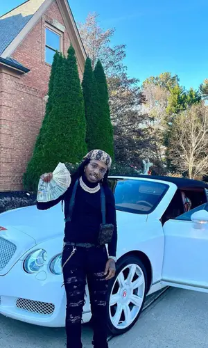 Jacquees wearing Louis Vuitton backpack