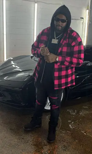 Peezy wearing Palm Angels shirt