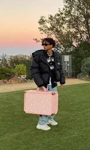 Jaden Smith wearing Jaden Smith Merch sneakers