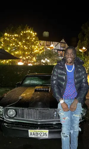 Russ Millions wearing Louis Vuitton belt