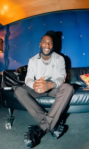 Burna Boy wearing Prada jacket