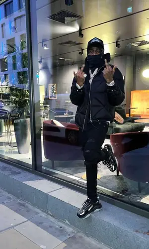 Russ Millions wearing Louis Vuitton belt