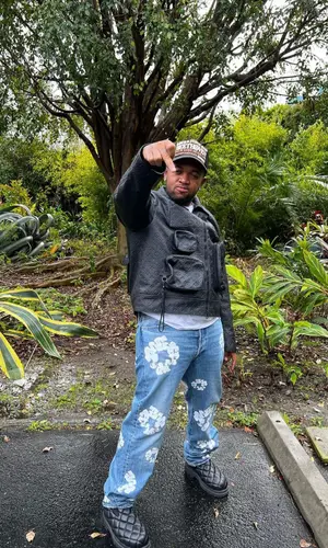 Mustard wearing Louis Vuitton jacket