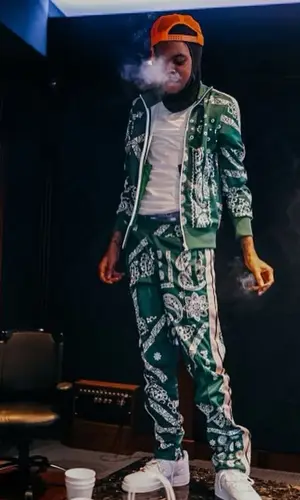 Lil Poppa wearing Palm Angels pants