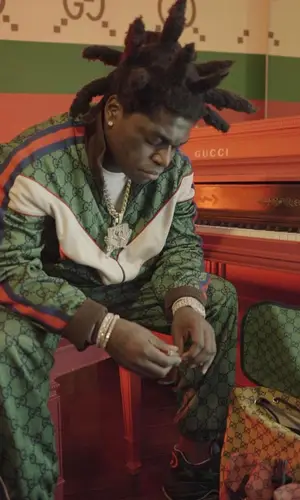 Kodak Black wearing Gucci backpack