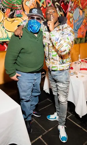 Bobby Shmurda wearing Louis Vuitton backpack