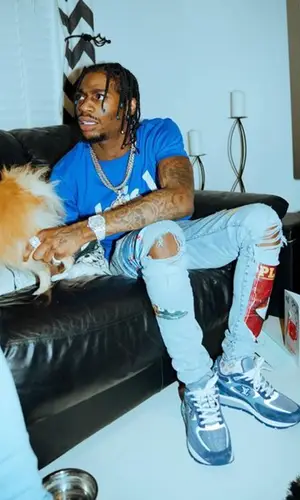 Russ Millions wearing Louis Vuitton t-shirt