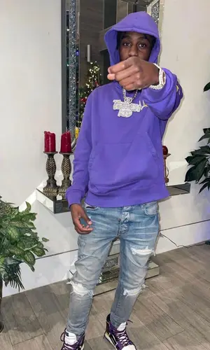 Lil Tjay wearing Amiri jeans