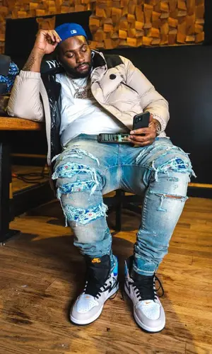 Peezy wearing Dior backpack
