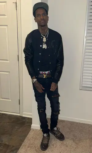 Lil Reese wearing Amiri jeans
