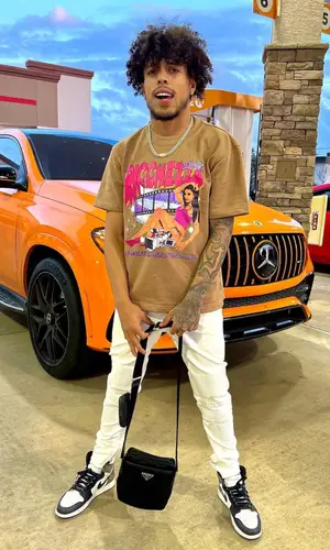King Cid wearing Prada bag