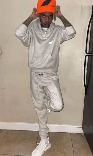 Lil Poppa wearing Fear of God pants