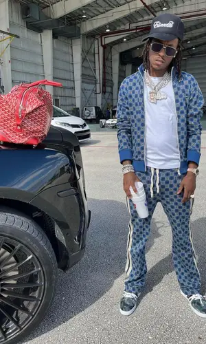 Rich The Kid wearing Goyard bag