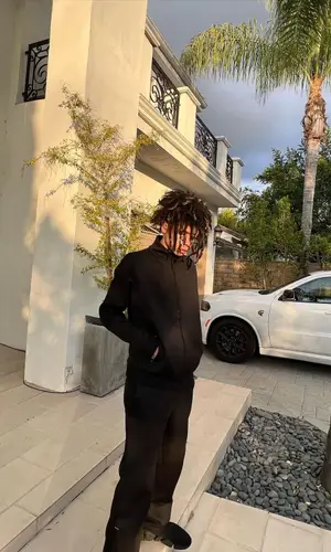 Iann Dior wearing Louis Vuitton pants