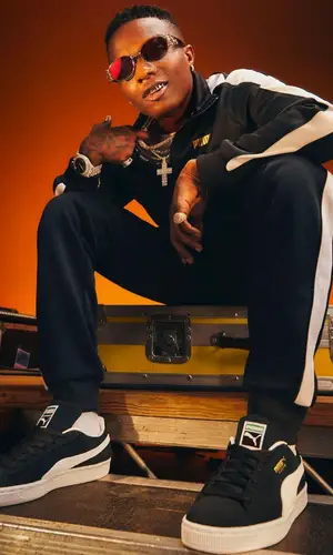 Wizkid wearing Puma jacket