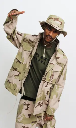 Black Kray wearing Fuck The Population jacket