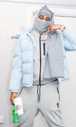 AJ Tracey’s Outfit in Trapstar Jacket, Louis Vuitton Hat & Sprite (2021)