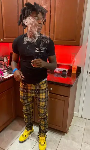 Jdot Breezy wearing Robins Jeans t-shirt