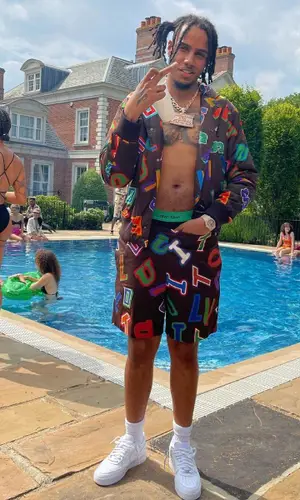 AJ Tracey wearing Louis Vuitton shorts