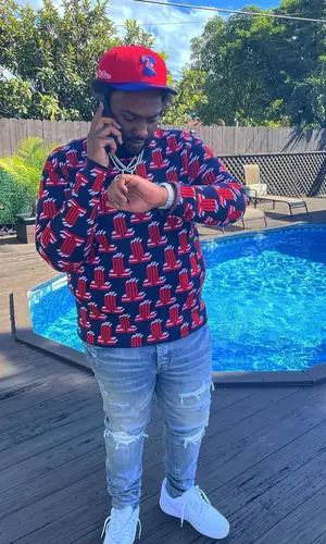 Peezy wearing Lanvin sweatshirt