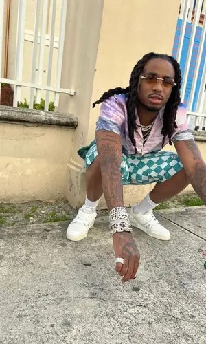 Quavo wearing Louis Vuitton shorts