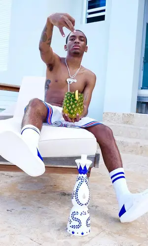 Bizzy Banks wearing Louis Vuitton shorts