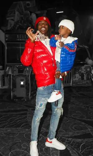 Polo G’s Outfit in Purple Brand Jeans, Alexander McQueen Sneakers & Moncler Hat (2022)