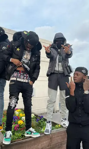 Russ Millions wearing Louis Vuitton t-shirt