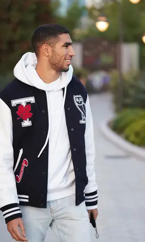 Achraf Hakimi’s Outfit in OVO Jacket, Off-White Sneakers & University of Toronto Varsity (2021)
