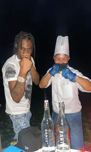 Russ Millions wearing Louis Vuitton t-shirt