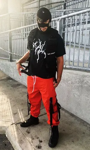 Lil Toe wearing Blacktailor pants