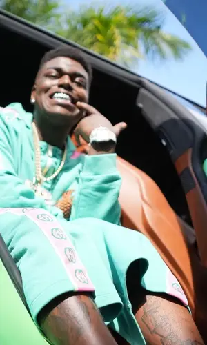 Kodak Black wearing Gucci sweatshirt