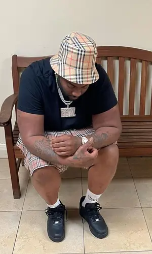 Peezy wearing Burberry swimwear