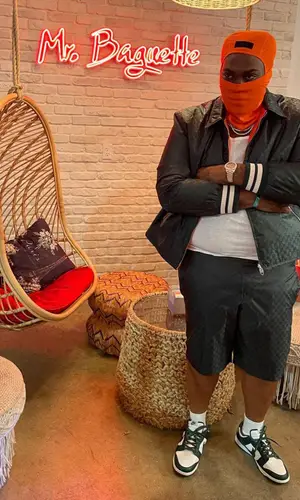 Peezy wearing Gucci swimwear