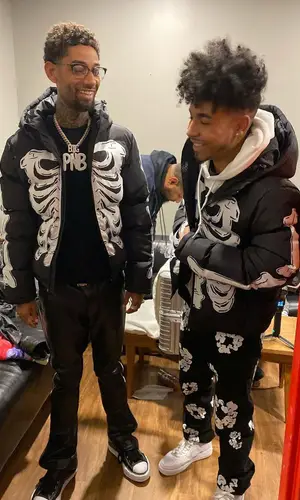 PnB Rock’s Outfit in TheWavyyWay Jacket, Cease±Desist Pants & Chrome Hearts Eyewear (2022)