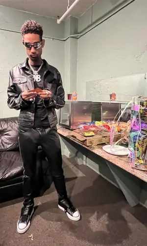 PnB Rock’s Outfit in Cease±Desist Jacket, Yeci Studios Backpack & Balenciaga Eyewear (2022)