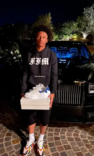 Mikey wearing Pusha T Merch sock